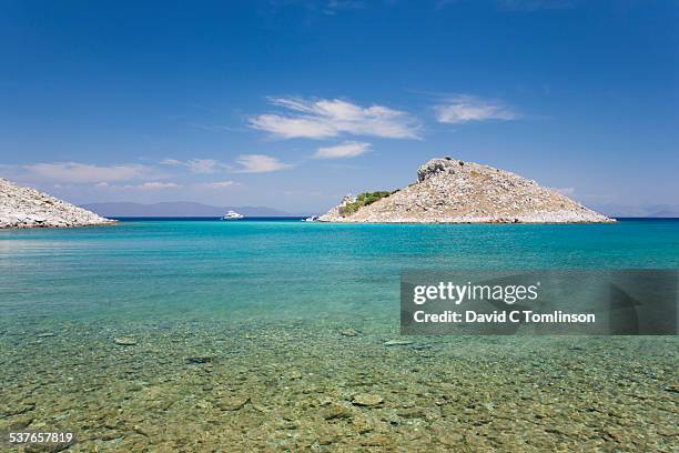 view across agia marina bay, pedi, symi, greece - symi stock pictures, royalty-free photos & images