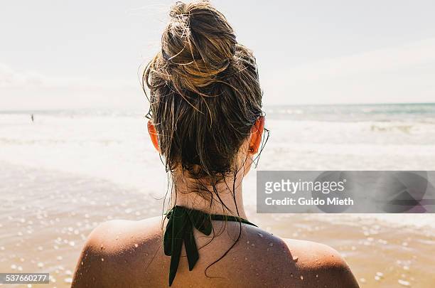 woman on sunny beach - haarknoten stock-fotos und bilder