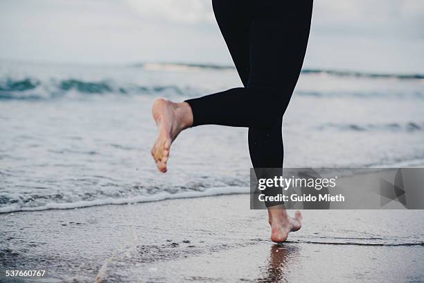 woman running barefooted - longeville sur mer stock pictures, royalty-free photos & images