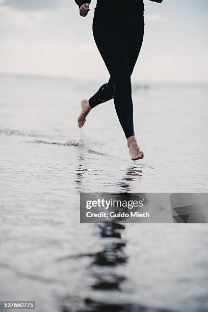 woman jogging seaside - longeville sur mer stock pictures, royalty-free photos & images