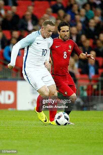 England's Wayne Rooney vies with Portugal's João Moutinho during an international friendly match between England and Portugal at Wembley Stadium in...
