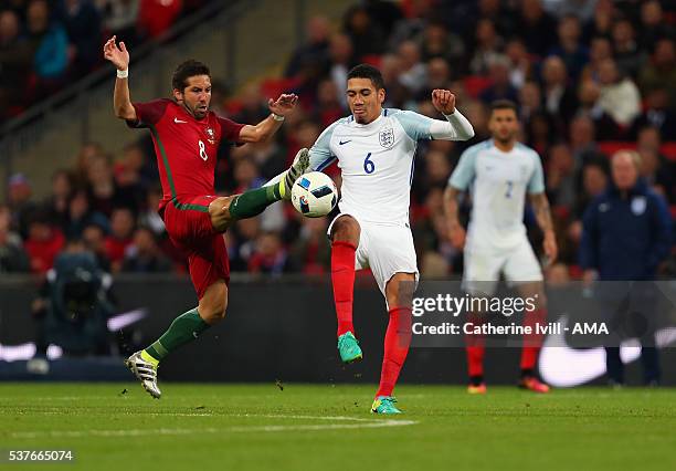 Joao Moutinho of Portugal and Chris Smalling of England during the International Friendly match between England and Portugal at Wembley Stadium on...