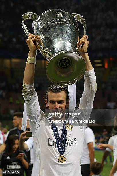 Gareth Bale of Real Madrid celebrates with the trophy following the UEFA Champions League Final between Real Madrid and Club Atletico de Madrid at...