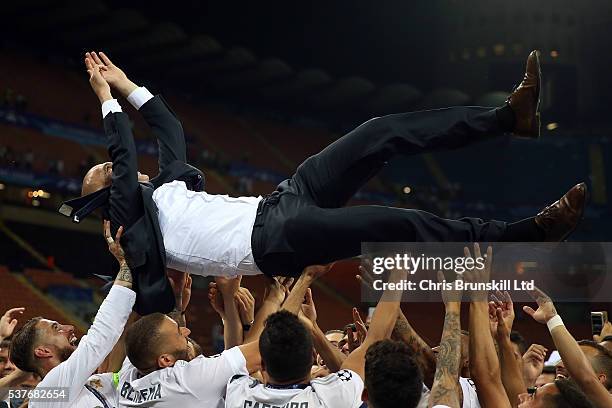 Real Madrid manager Zinedine Zidane is thrown in the air following the UEFA Champions League Final between Real Madrid and Club Atletico de Madrid at...