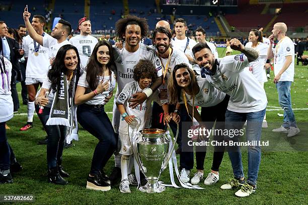 Marcelo of Real Madrid poses with the trophy alongside his family following the UEFA Champions League Final between Real Madrid and Club Atletico de...