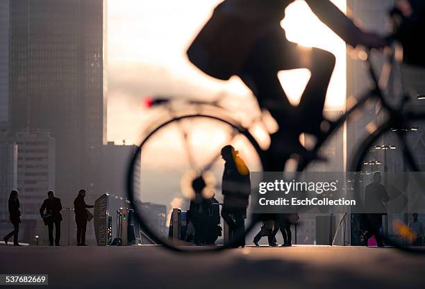 businessman on bicycle passing skyline la defense - transport paris stock pictures, royalty-free photos & images