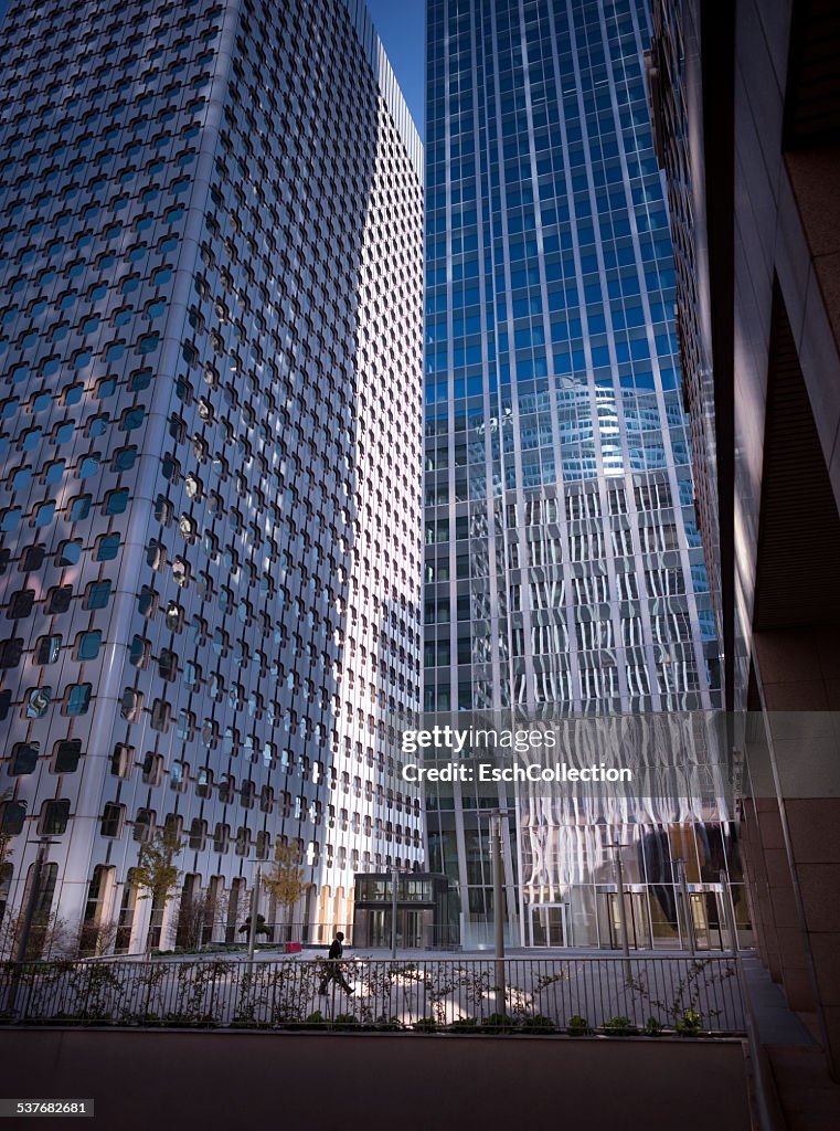 Businessman passing majestic office buidings