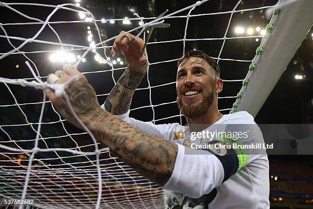 Sergio Ramos of Real Madrid cuts the goal netting following the UEFA Champions League Final between Real Madrid and Club Atletico de Madrid at Stadio...