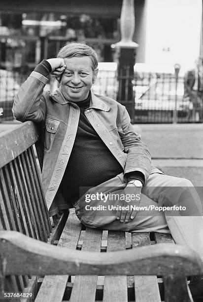 American musician Mel Torme pictured sitting on a bench in London on 17th June 1976.