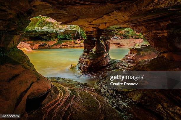 sea cave at sand island - sandstein stock-fotos und bilder