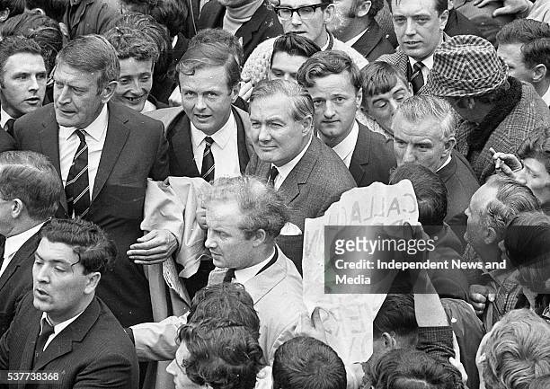 Elevated view of British Home Secretary James Callaghan and Irish politician John Hume amidst a crowd as the Secretary visits the Bogside...