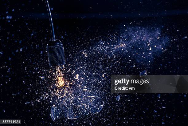 bulb explosion - exploding lightbulb stock pictures, royalty-free photos & images