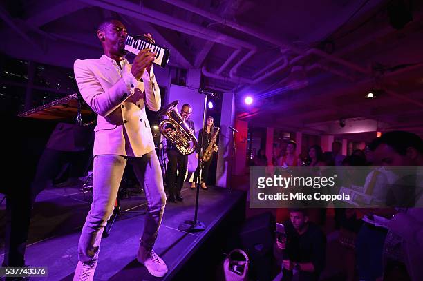 Musician Jon Batiste and Stay Human perform onstage during The Supper hosted by Mario Batali with Anthony Bourdain on June 2, 2016 in New York City.