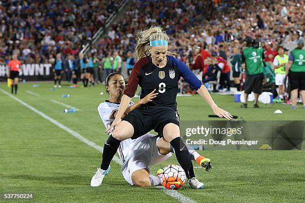 Yuki Ogimi of Japan receives her second yellow card of the game for fouling Julie Johnston of United States of America and is ejected in the 57th...