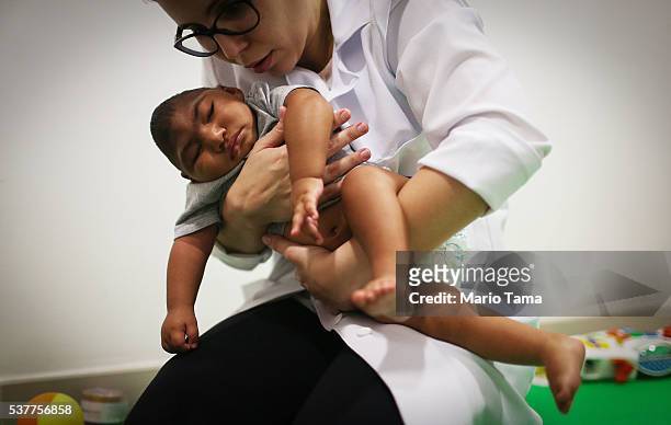 Dr. Stella Guerra performs physical therapy on an infant born with microcephaly at Altino Ventura Foundation on June 2, 2016 in Recife, Brazil....
