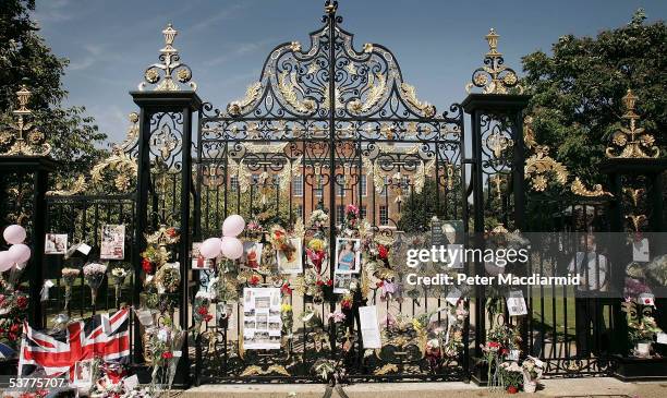 Flowers, photographs and tributes are placed in memory of Princess Diana, Princess of Wales on the gates of Kensington Palace on 31 August 2005 in...