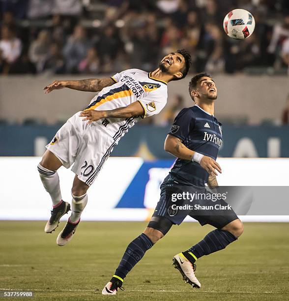 DeLaGarza of Los Angeles Galaxy heads the ball during Los Angeles Galaxy's MLS match against Sporting KC at the StubHub Center on June 2, 2016 in...