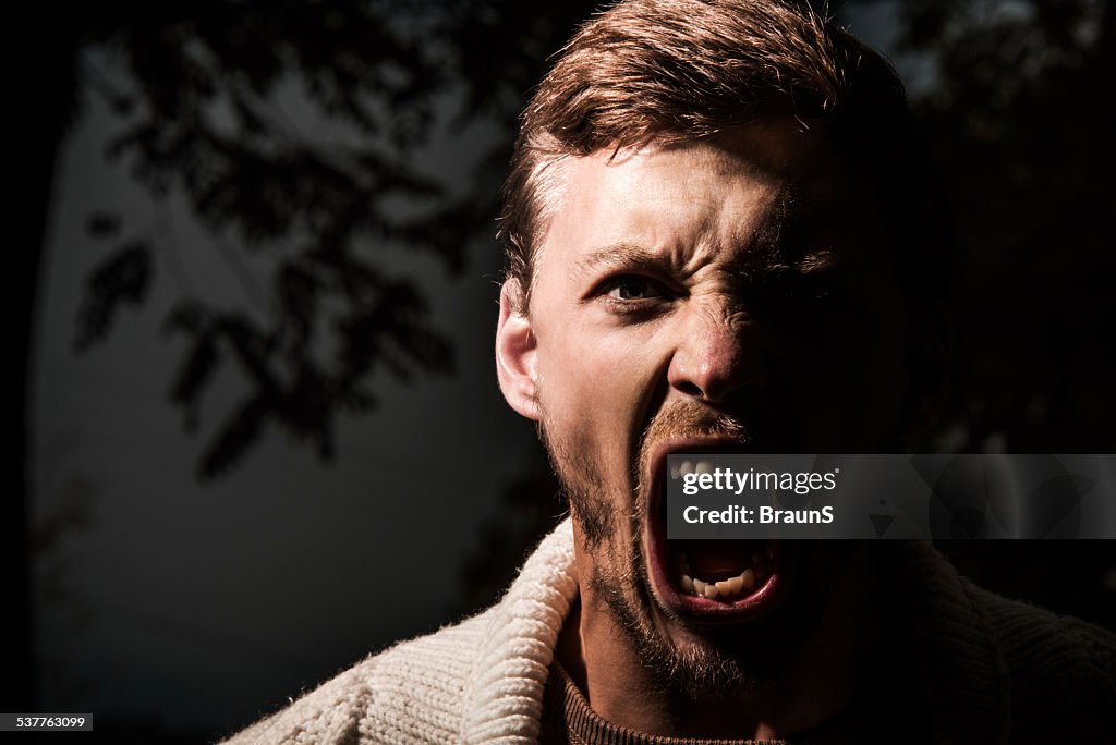 Furious man outdoors.