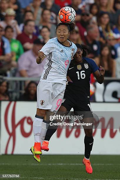 Yuki Ogimi of Japan heads the ball away from Crystal Dunn of United States of America during an international friendly match at Dick's Sporting Goods...