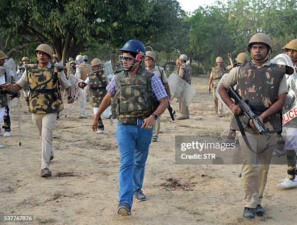 Indian police patrol during clashes with members of a sect said to have been living illegally at the Jawahar Bagh park in Mathura on June 2, 2016....