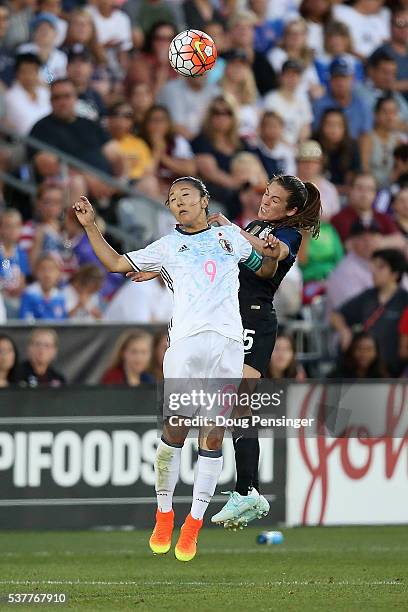 Yuki Ogimi of Japan and Kelley O'Hara of United States of America vie for a head ball during an international friendly match at Dick's Sporting Goods...