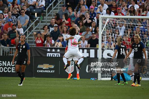 Yuki Ogimi of Japan celebrates her goal against Hope Solo of United States of America with Mizuho Sakaguchi of Japan as Morgan Brian and Allie Long...