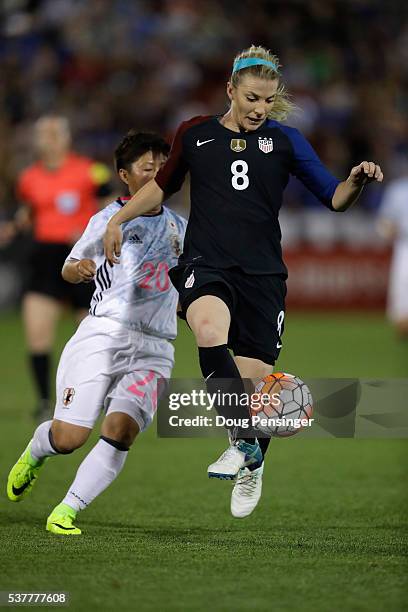 Julie Johnston of United States of America controls the ball against Kumi Yokoyama of Japan during an international friendly match at Dick's Sporting...