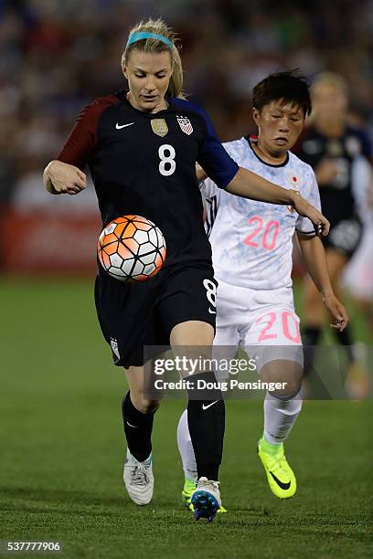 Julie Johnston of United States of America controls the ball against Kumi Yokoyama of Japan during an international friendly match at Dick's Sporting...