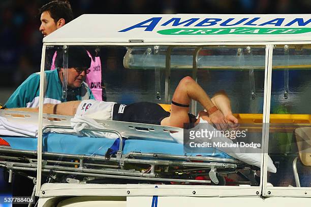 Steven Morris of the Tigers reacts after he suffers a leg injury in a contest with Robin Nahas of the Kangaroos during the round 11 AFL match between...