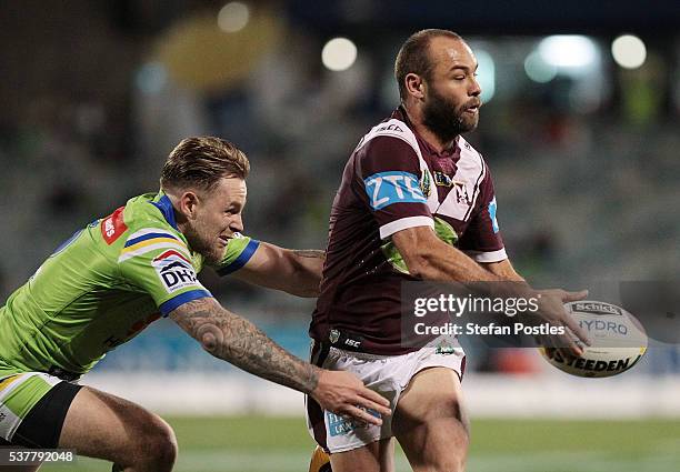 Brett Stewart of the Sea Eagles is tackled during the round 13 NRL match between the Canberra Raiders and the Manly Sea Eagles at GIO Stadium on June...