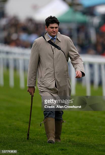 Hugo Palmer on the course with his going stick at Epsom Racecourse on June 3, 2016 in Epsom, England.