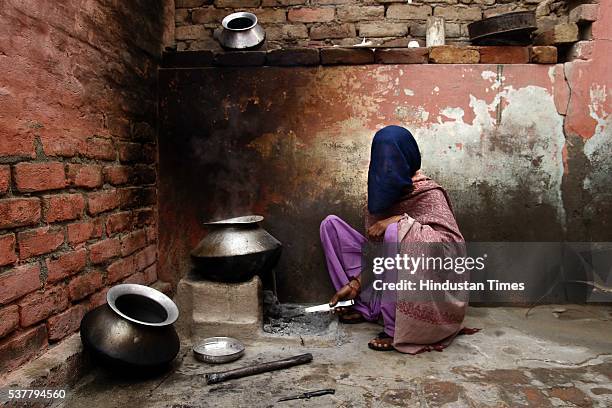 Gayatri, one of the trafficked girls who were lured into marriage by traffickers cooking food at her house on March 15, 2014 in Jind, India....