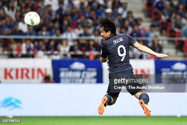 Shinji Okazaki of Japan heads the ball to score his team's first goal during the international friendly match between Japan and Bulgaria at the...