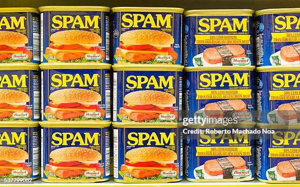 Spam canned meat stacked vertically in store shelf. Spam is a brand of canned precooked meat products made by Hormel Foods Corporation.