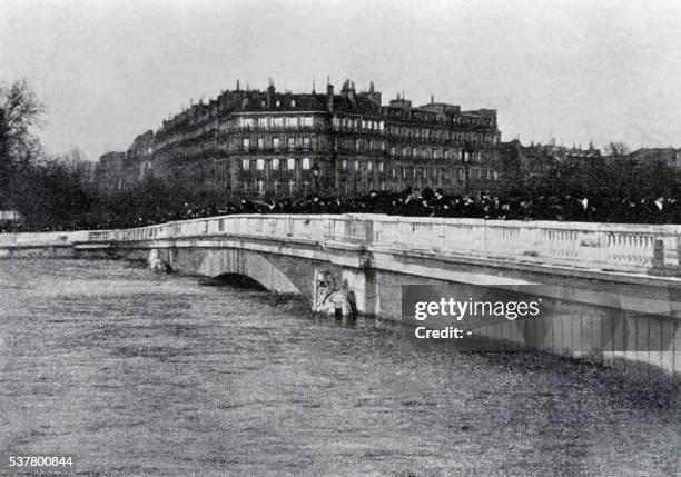 Photo taken on January 27, 1910 shows people on the Alma bridge in Paris as the statue of the Zouave soldier was partially submerged when the Seine...