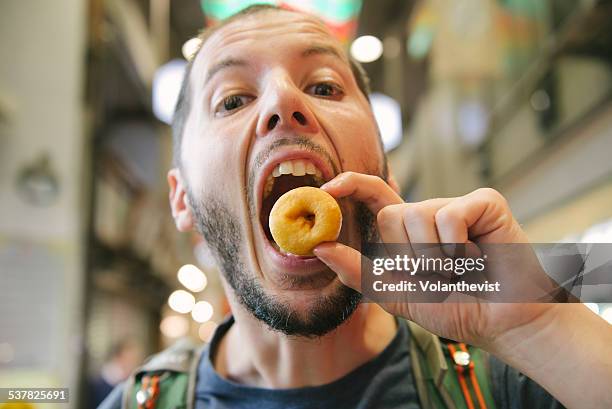 Man Eating Small Donuts In Nishiki Market Kyoto High-Res Stock Photo