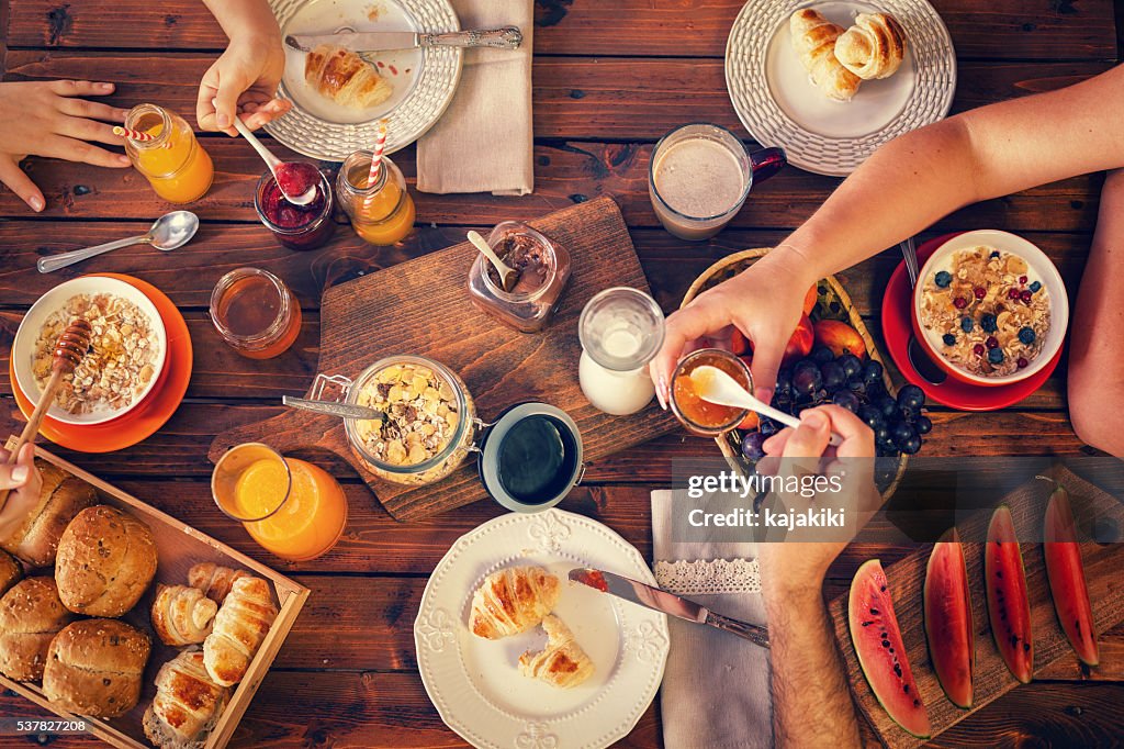 Young Happy Family Having Breakfast