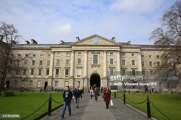 People walk at the entrance to Trinity College on April 19, 2016 in Dublin, Ireland. Illustrative picture of the Irish capital city center.