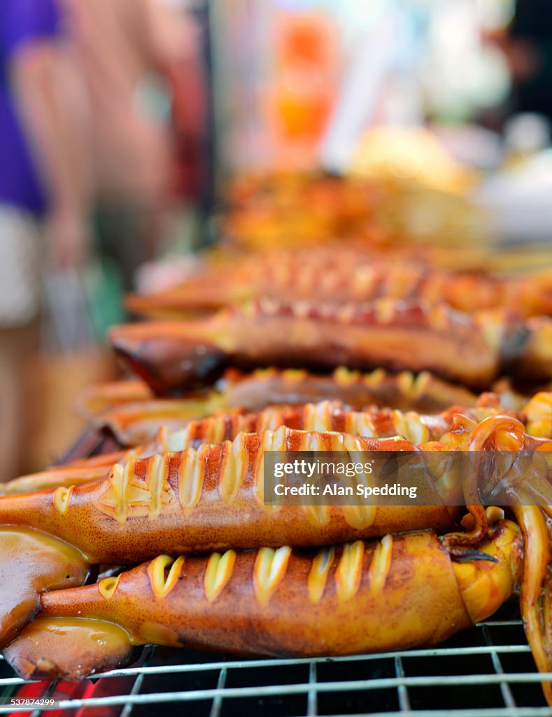 BBQ Squid for sale on a Thai beach food stall.