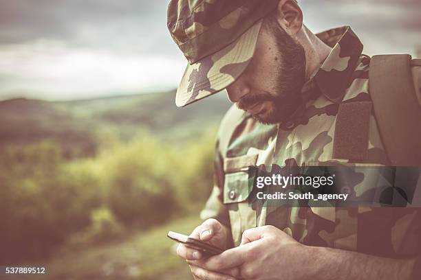 army man with smart phone - woodland camo stock pictures, royalty-free photos & images