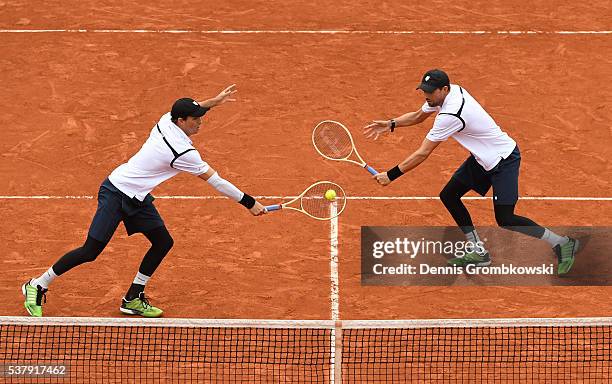 Mike Bryan and Bob Bryan of the United States in action during the Men's Doubles semi final match against Lukasz Kubot of Poland and Alexander Peya...
