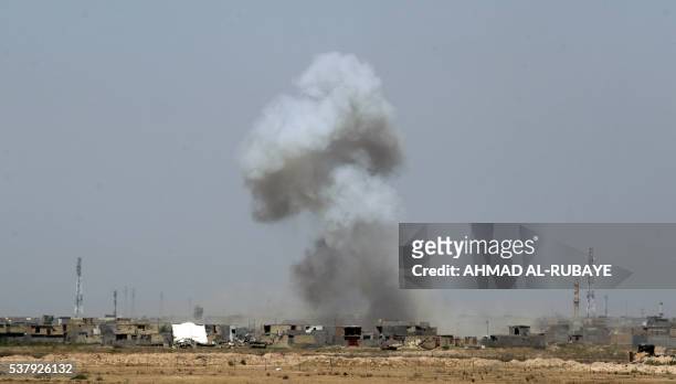 Smoke billows after shelling on al-Shuhada neighborhood, south of Fallujah, during an operation by Iraqi government forces to regain control of the...