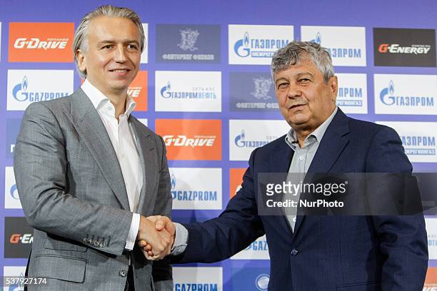 President of FC Zenit Saint Petersburg Alexander Dyukov shakes hands with Mircea Lucescu during his first press conference as head coach of FC Zenit...