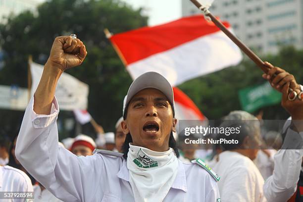 Members of Islamic Defenders Front shout slogan during a rally to an anti-communism campaign in Jakarta, Indonesia, on June 03, 2016. On May,...