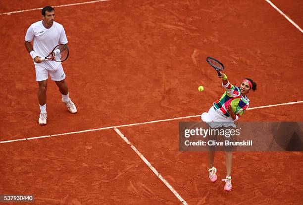 Sania Mirza of India and Ivan Dodig of Croatia in action during the Mixed Doubles final match against Martina Hingis of Switzerland and Leander Paes...