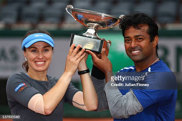 Martina Hingis of Switzerland and Leander Paes of India lift the trophy following victory during the Mixed Doubles final match against Sania Mirza of...
