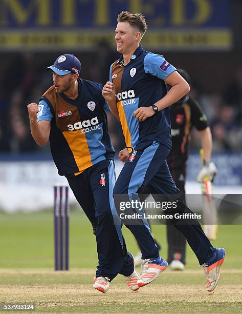Matt Critchley of Derbyshire Falcons is congratulated by Alex Hughes on taking the wicket of Ben Raine of Leicestershire Foxes during the NatWest T20...
