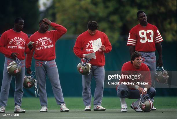 San Francisco 49ers George Cooper , Kevin Dean , Jeff Stover , and Clyde Glover casual on field during practice session at Red Morton Park. 49ers...