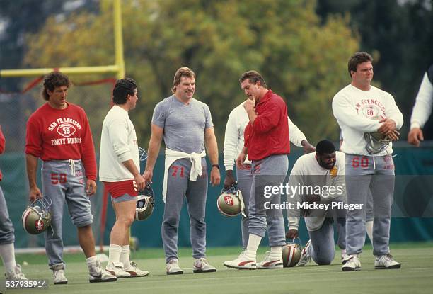 San Francisco 49ers Keith Browner , Randy Cross , Keith Fahnhorst , Greg Liter , and Chuck Thomas casual on field during practice session at Red...