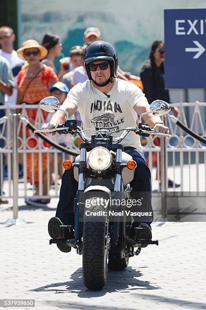 Mark Wahlberg rides a motorcycle at "Extra" at Universal Studios Hollywood on June 3, 2016 in Universal City, California.